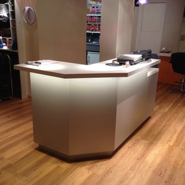 Coiffure Salon mit Theke in Kunstharz, LED Beleuchtung. Strapazierfähiger Vinylboden in Holzoptik.